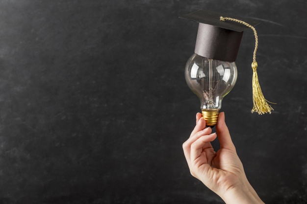 person-holding-light-bulb-with-graduation-cap_23-2148721299